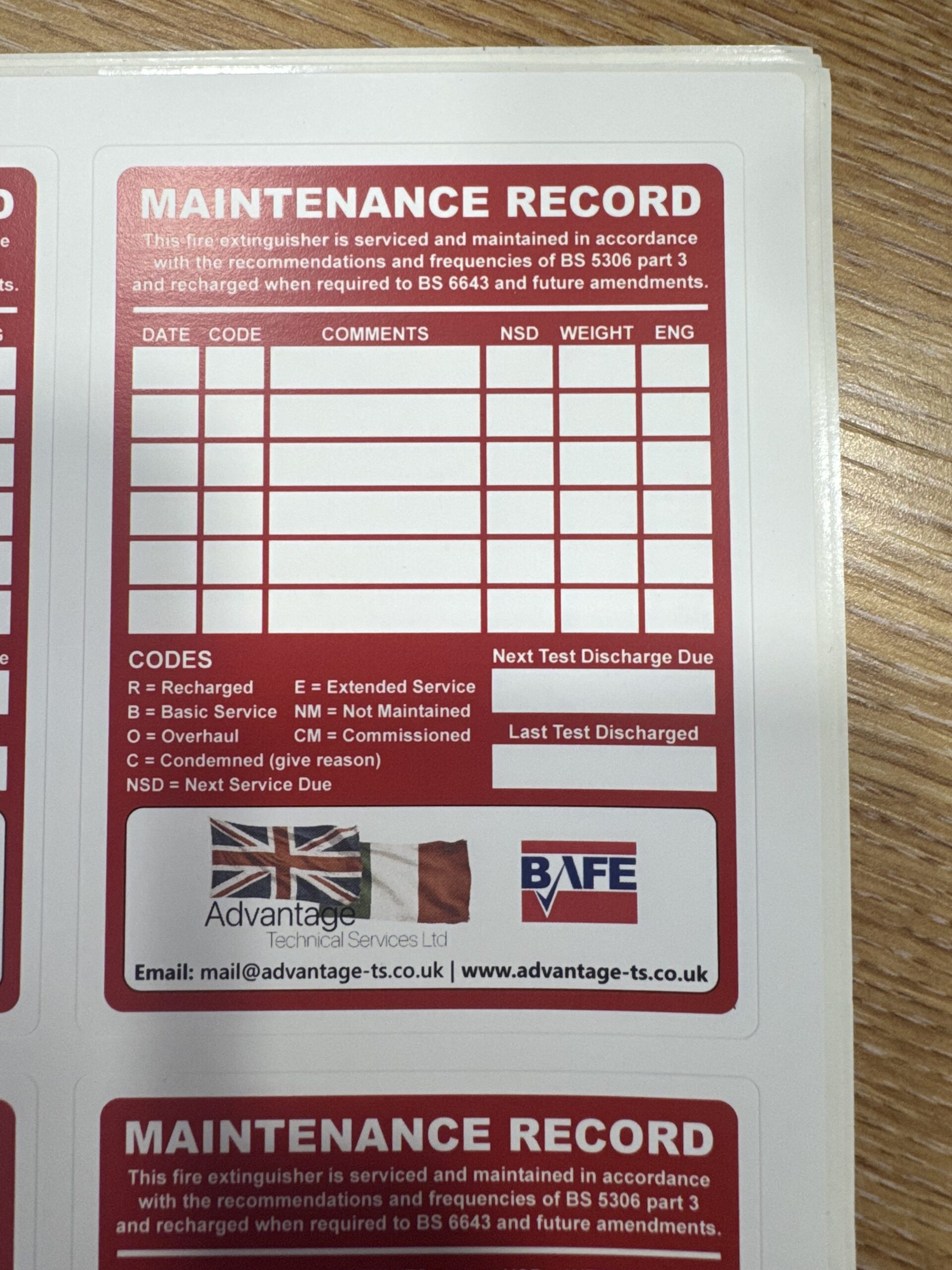 Fire extinguisher maintenance label showing the date of the last service